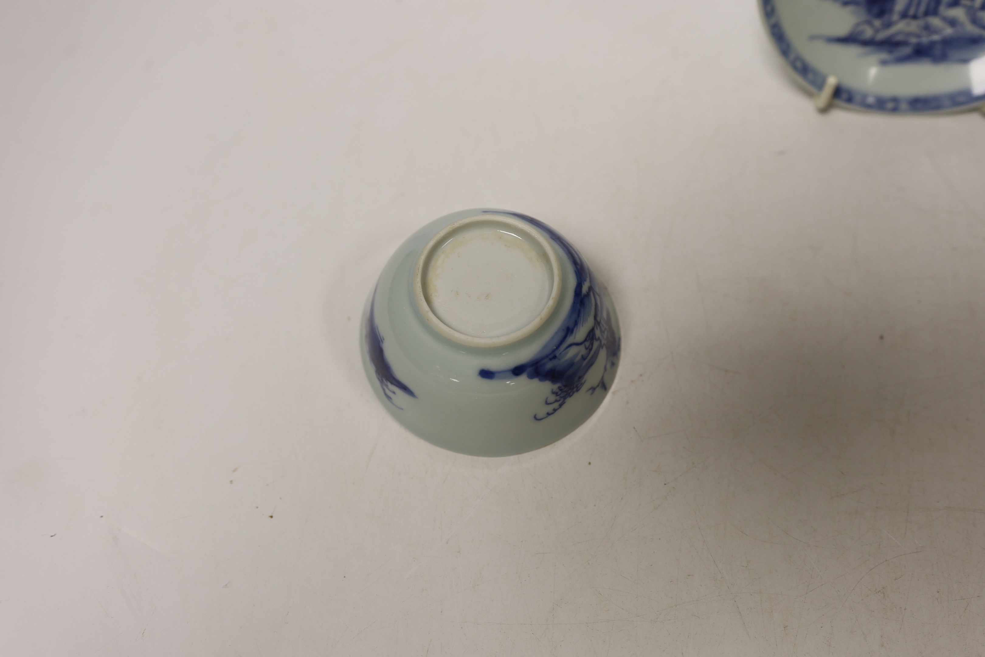 A Chinese Nanking Cargo blue and white saucer and tea bowl, and a Kangxi blue and white tea bowl, largest 11.5cm in diameter